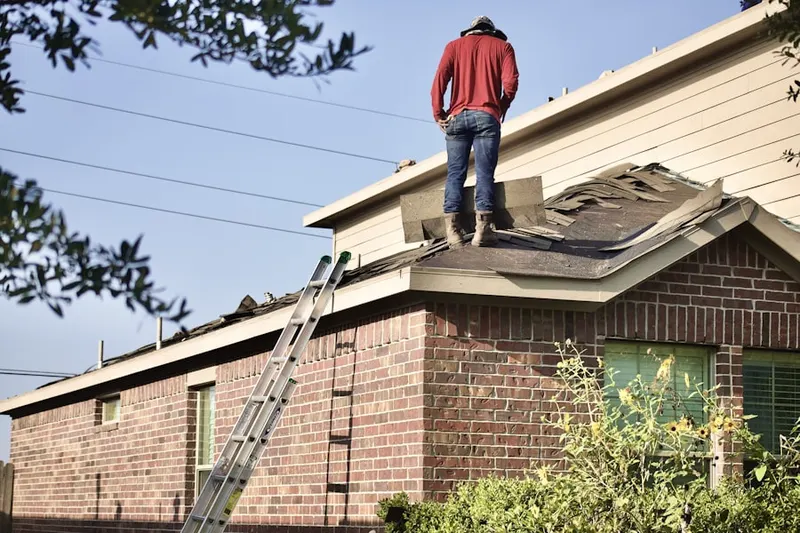 Professional roofer working on a residential roof in Wyandanch